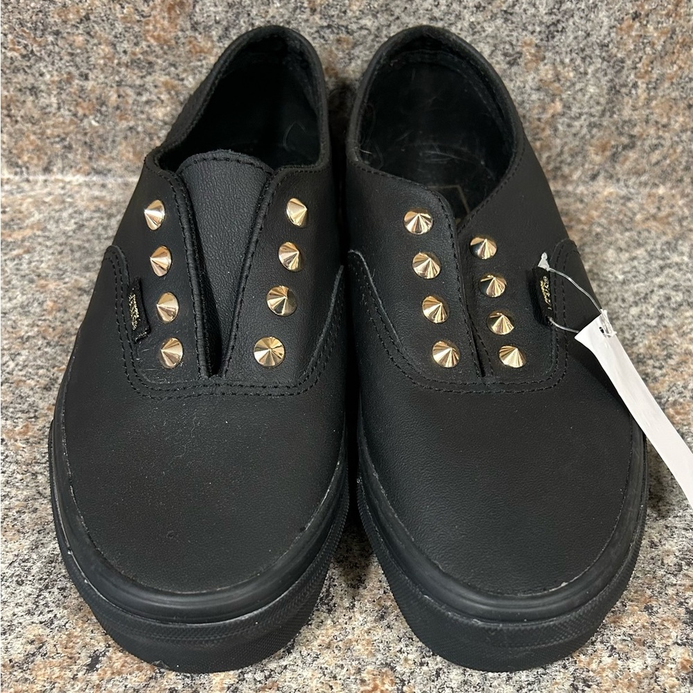 Black slip on vans with gold spikes